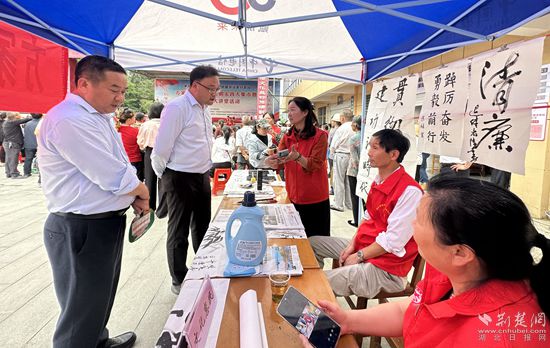 “文化惠民”攤位上，志愿者展示書(shū)法作品_副本.jpg
